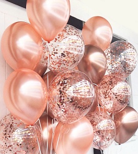 15 Rose gold helium gas inflated birthday balloons tied with ribbons