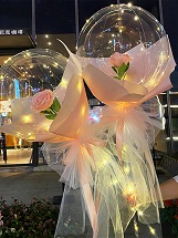 2 Pink Roses rose inside 2 transparent balloon with red and White Wrapping with fairy light