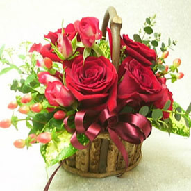 6 red roses in a small basket