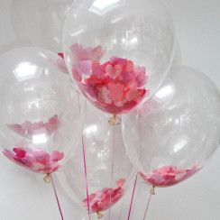 Four Transparent Balloons stuffed with pink petals