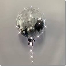 1 Bubble transparent balloon with happy birthday print on balloon and balck silver balloons inside and led light