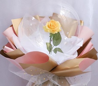 Transparent Balloon with 1 Yellow rose inside and wrapped in white and pale yellow wrapping