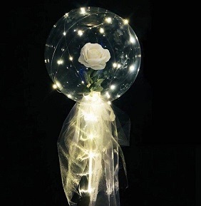 Trasparent balloon stuffed with one white rose with white wrapping and led lights