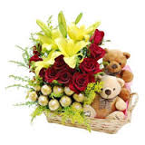 16 Ferrero rocher Chocolates and 2 Teddy bears 4 Yellow lilies 12 red roses in same basket