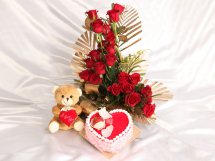 1 Kg Heart Black forest Cake with 20 red roses in a basket and 6 inches Teddy bear