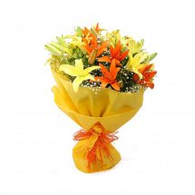 Yellow and orange lilies in a hand bouquet