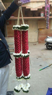 A pair of Bride and Groom Red floral Garlands in red flowers