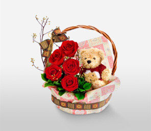 Teddy bear (6 inches) with 5 short stems of red roses in the same Basket